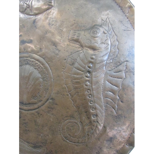 530 - A Newlyn School style copper wall plaque with a central scallop shell and a surround of seahorses an... 