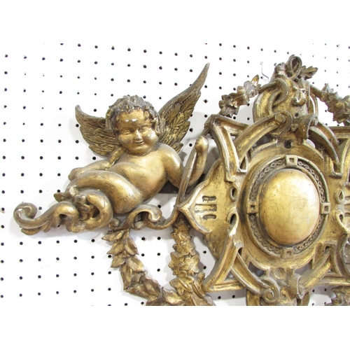 536 - A 19th century carved wooden church ornament with cherubs and garlands with a gilt on gesso finish, ... 