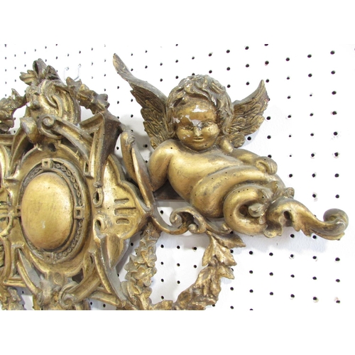 536 - A 19th century carved wooden church ornament with cherubs and garlands with a gilt on gesso finish, ... 