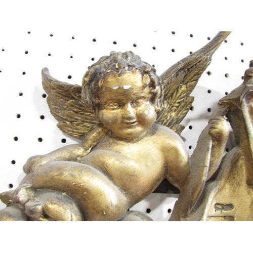 536 - A 19th century carved wooden church ornament with cherubs and garlands with a gilt on gesso finish, ... 