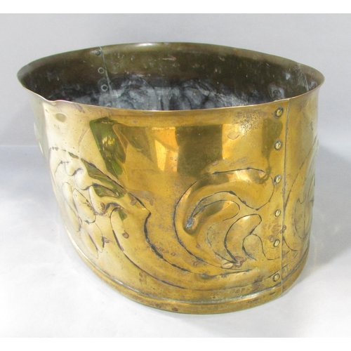 542 - An oval Arts & Crafts brass planter with embossed trailing flowers and riveted joins, no maker's mar... 