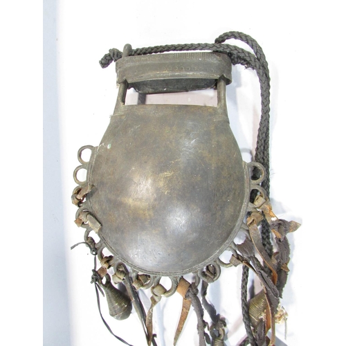 543 - An African Benin bronze purse, with incised coin circle and semi-circles to the body hung with bells... 