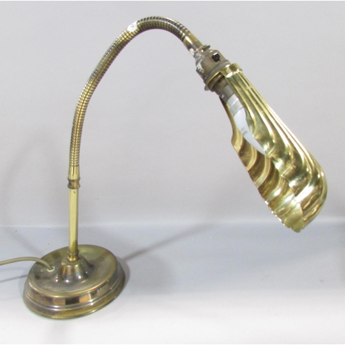 558 - An Edwardian brass reading lamp with a shell shade on a flexible arm.