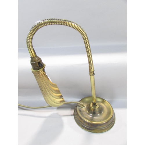 558 - An Edwardian brass reading lamp with a shell shade on a flexible arm.