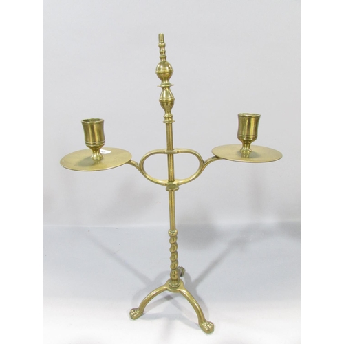 559 - A19th century brass adjustable candlestick raised on tripod paw supports, 38cm high, together with a... 