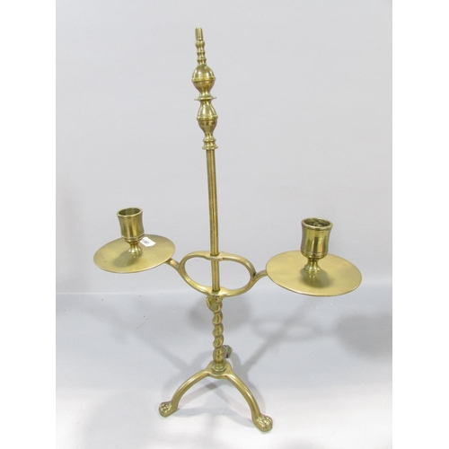 559 - A19th century brass adjustable candlestick raised on tripod paw supports, 38cm high, together with a... 