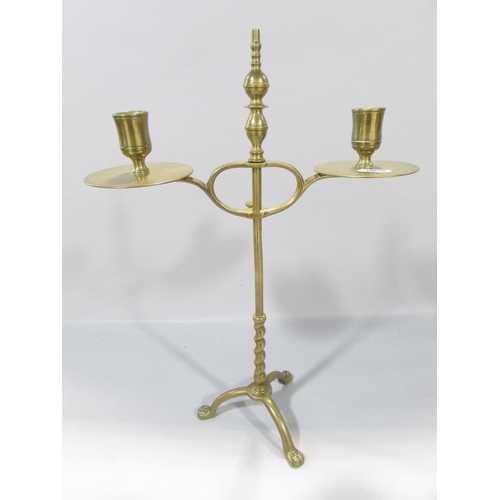 559 - A19th century brass adjustable candlestick raised on tripod paw supports, 38cm high, together with a... 