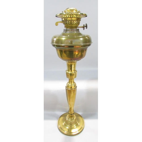 559 - A19th century brass adjustable candlestick raised on tripod paw supports, 38cm high, together with a... 