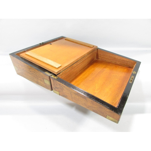 569 - A Georgian walnut writing slope with a black leather lined interior.