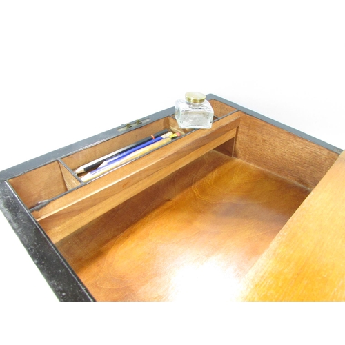 569 - A Georgian walnut writing slope with a black leather lined interior.