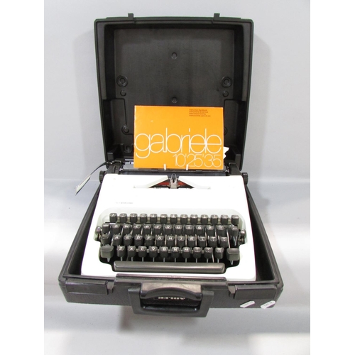 572 - An Adler “gabriele 25” Typewriter made in West Germany, with a hard plastic carry case.