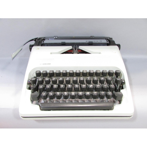 572 - An Adler “gabriele 25” Typewriter made in West Germany, with a hard plastic carry case.