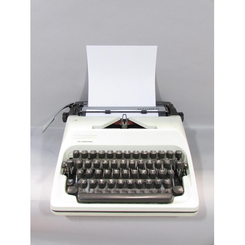 572 - An Adler “gabriele 25” Typewriter made in West Germany, with a hard plastic carry case.