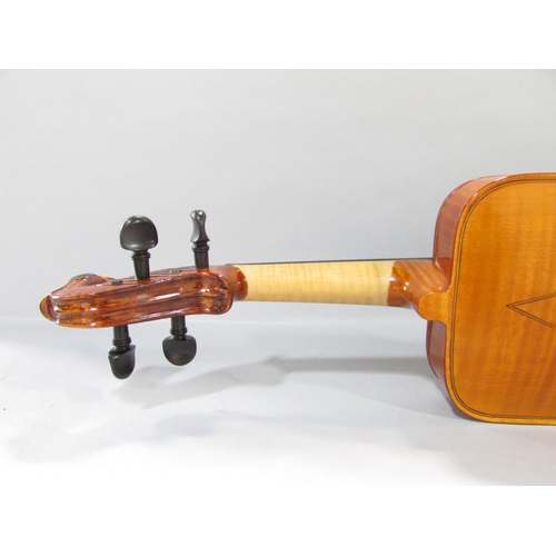 579 - A hand made unconventional violin, with a squared off body with a bird carved scroll, made by Willia... 