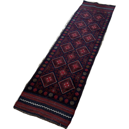 1773 - A Meswani runner with a red and blue all over diamond pattern 229 x 60 approximately