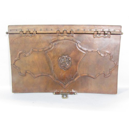 544 - A large leather desk blotter with a heraldic embossed hinged cover together with a matching note pad... 