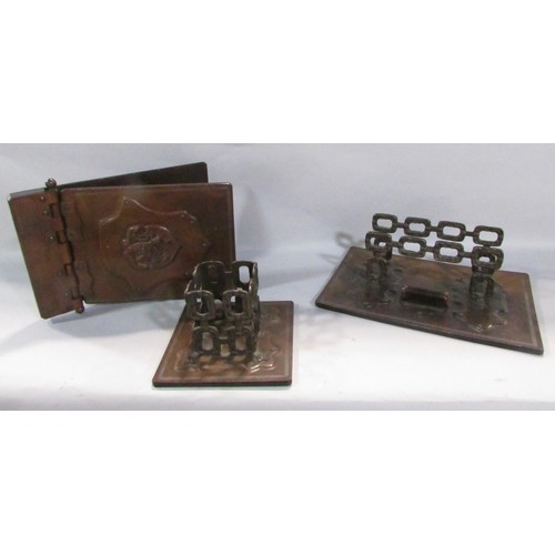 544 - A large leather desk blotter with a heraldic embossed hinged cover together with a matching note pad... 