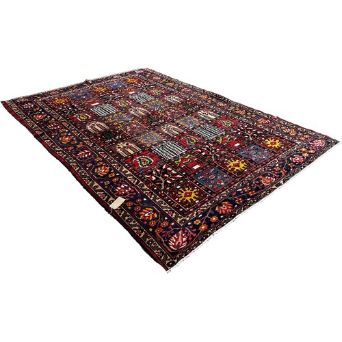 1768 - Bahktia carpet with an all over floral panelled pattern, 310cm x 216cm approximately