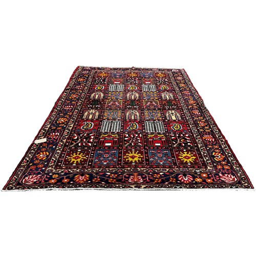 1768 - Bahktia carpet with an all over floral panelled pattern, 310cm x 216cm approximately