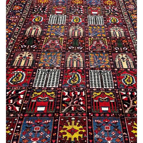 1768 - Bahktia carpet with an all over floral panelled pattern, 310cm x 216cm approximately