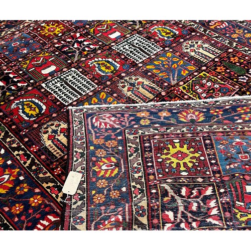 1768 - Bahktia carpet with an all over floral panelled pattern, 310cm x 216cm approximately