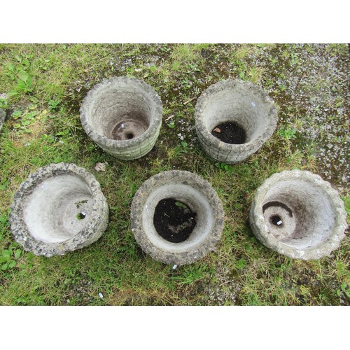 1067 - A set of five matching circular cast composition stone barrel shaped planters, with repeating flower... 