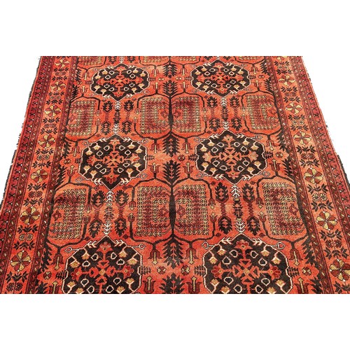 1760 - A Persian style carpet with alternating guls on a faded red ground, 199cm x 144cm.