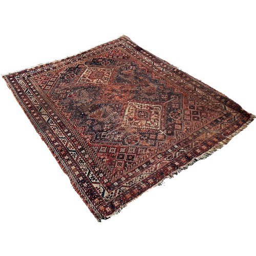 1754 - An antique Persian rug with three interlocking diamond medallions in the centre, 195cm x 146cm appro... 