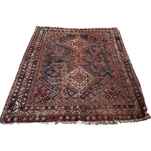 1754 - An antique Persian rug with three interlocking diamond medallions in the centre, 195cm x 146cm appro... 