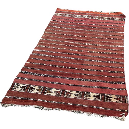 1753 - An Afghan red and black ground kilim 175cm x 106cm approximately