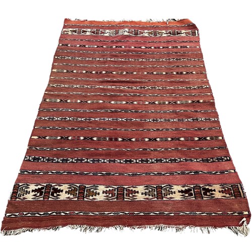 1753 - An Afghan red and black ground kilim 175cm x 106cm approximately