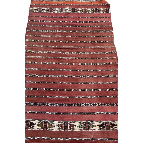 1753 - An Afghan red and black ground kilim 175cm x 106cm approximately