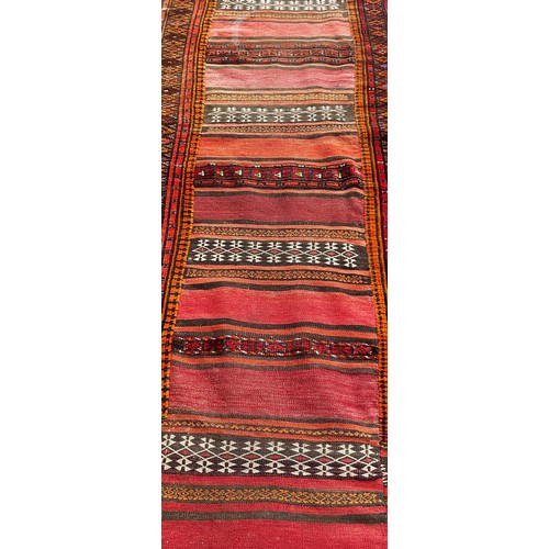 1761 - An old kilim runner with a striped central panel, 280cm x 80cm approximately together with another k... 