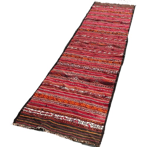 1761 - An old kilim runner with a striped central panel, 280cm x 80cm approximately together with another k... 