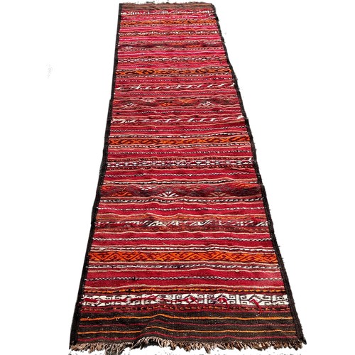 1761 - An old kilim runner with a striped central panel, 280cm x 80cm approximately together with another k... 