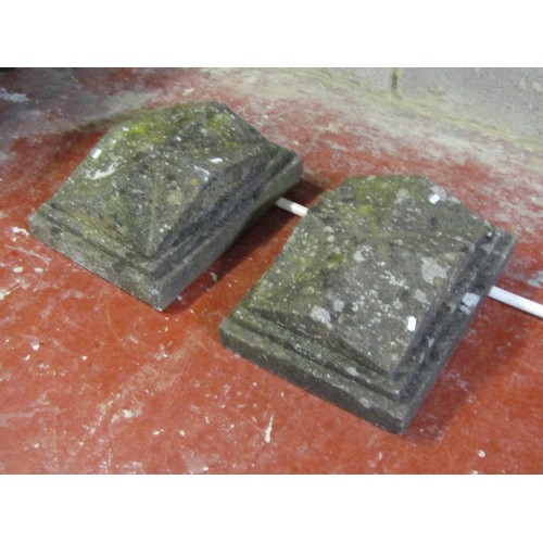 1113 - A pair of weathered cast composition stone pier caps of stepped rectangular and squat pyramid form, ... 