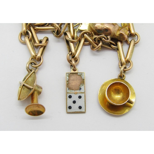 360 - 9ct fancy link charm bracelet hung with novelty charms to include a cup and saucer, enamelled playin... 