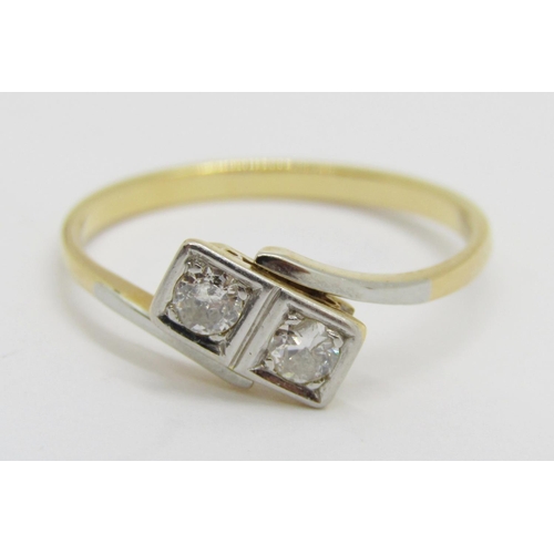 390 - Two stone diamond crossover ring in yellow metal with white metal setting, each stone 0.10ct approx,... 