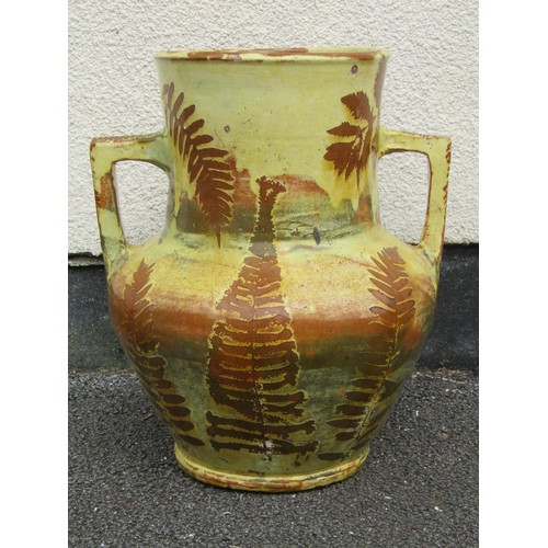 1699 - A slip glazed fern and landscape pattern earthen ware two handled vase, 41cm high