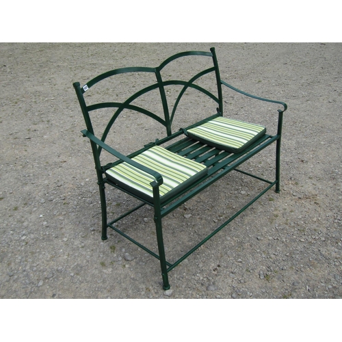 1037 - A Regency style green painted two-seat metal garden bench, with strap-work back, 91cm high, 115cm wi... 