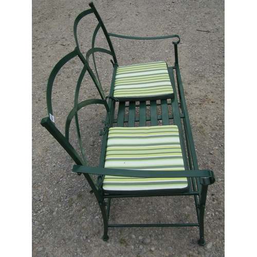 1037 - A Regency style green painted two-seat metal garden bench, with strap-work back, 91cm high, 115cm wi... 