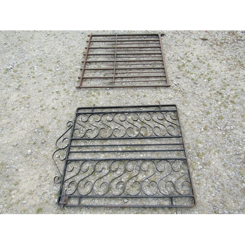 1078 - A heavy gauge ironwork garden gate, with open vertical rails, 94cm high, 96 wide together with one o... 