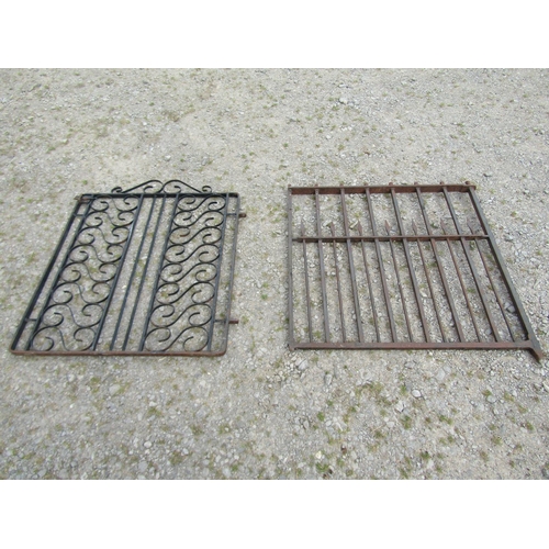 1078 - A heavy gauge ironwork garden gate, with open vertical rails, 94cm high, 96 wide together with one o... 