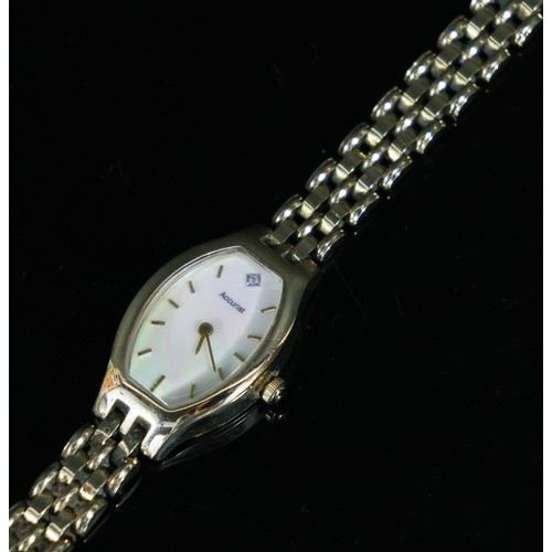 472 - Accurist: A lady's 9ct yellow gold cased wristwatch, with polished shell dial, on 9ct yellow gold st... 