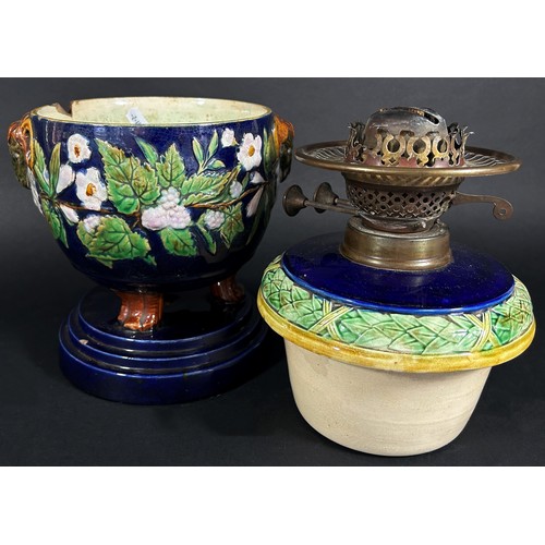 104 - A Victorian Majolica type ceramic oil lamp with loose cover, Duplex burner and opaque globular shade... 