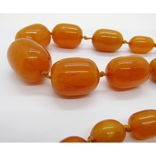 420 - Long graduated amber coloured bead necklace, largest bead 3 x 2.2cm approx, 135g