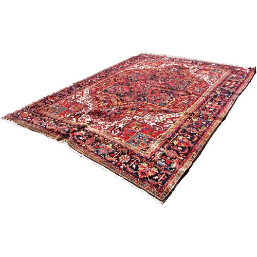 1793 - A good quality Heriz carpet, with an all over stylised floral and geometric pattern, 370cm x 270cm a... 