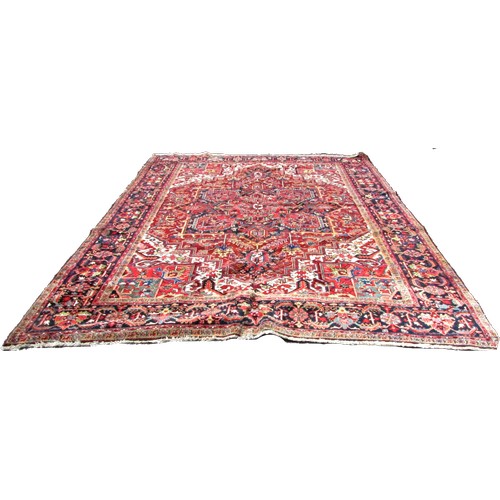 1793 - A good quality Heriz carpet, with an all over stylised floral and geometric pattern, 370cm x 270cm a... 