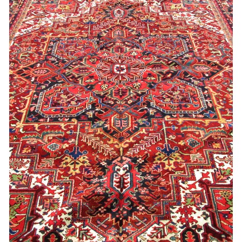 1793 - A good quality Heriz carpet, with an all over stylised floral and geometric pattern, 370cm x 270cm a... 