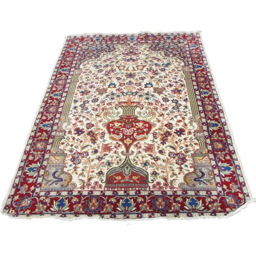 1786A - A Persian style wool rug with a tree of life type design and trailing floral borders 195cm x 120cm a... 